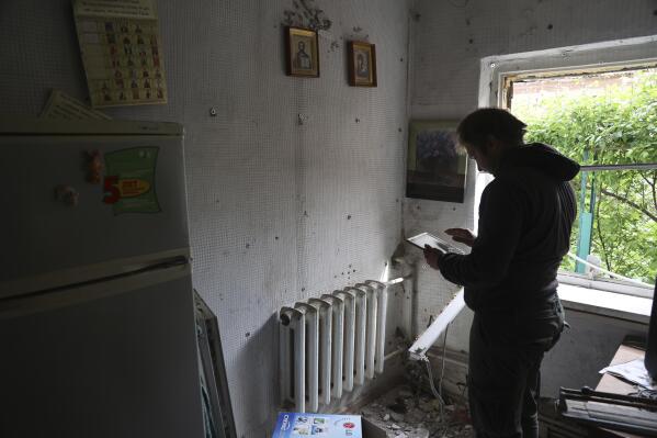 A man stands in a house damaged by shelling in Mariupol, in territory under the government of the Donetsk People's Republic, eastern Ukraine, Saturday, May 21, 2022. (AP Photo/Alexei Alexandrov)