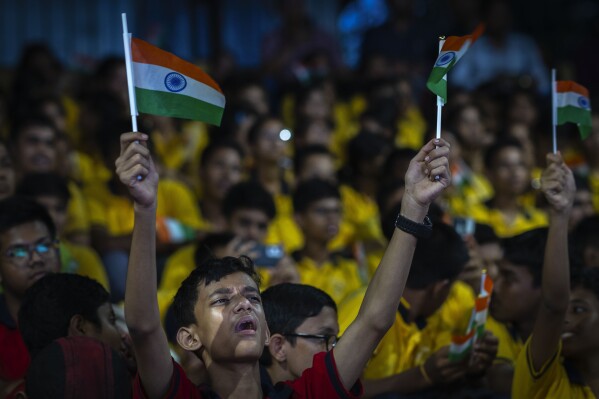 Schoolchildren celebrate the successful landing of spacecraft Chandrayaan-3 on the moon, in a school in Guwahati, India, Wednesday, Aug. 23, 2023. (AP Photo/Anupam Nath)