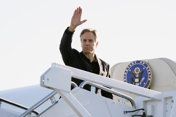 Secretary of State Antony Blinken waves as he boards a plane, Tuesday, April 23, 2024, at Andrews Air Force Base, Md., en route to China. (AP Photo/Mark Schiefelbein, Pool)