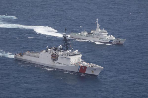 In this photo provided by U.S. Coast Guard, Coast Guard cutter Munro, bottom, and Japan Coat Guard patrol vessel Large Aso transit together in formation during a maritime engagement in the East China Sea on Aug. 25, 2021. China's defense ministry protested Saturday, Aug. 28, 2021 the passage of a U.S. Navy warship and Coast Guard cutter through the waters between China and Taiwan, a self-governing island claimed by China. (U.S. Coast Guard via AP)