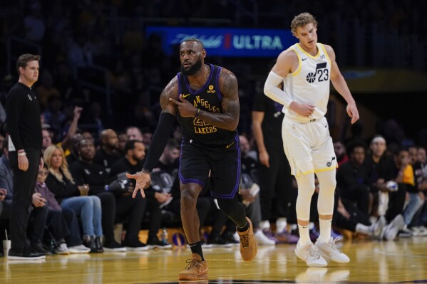 Los Angeles Lakers forward LeBron James, center, reacts after making a 3-point basket during the first half of the team's NBA basketball In-Season Tournament game against the Utah Jazz, Tuesday, Nov. 21, 2023, in Los Angeles. James became the first player in NBA history to surpass 39,000 career points. (AP Photo/Ryan Sun)