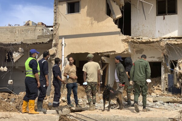 Rescue teams search for victims in Derna, Libya, on Sunday, Sept. 17, 2023. Libyan authorities have opened an investigation into the collapse of two dams that caused a devastating flood in a Derna as rescue teams searched for bodies on Saturday, nearly a week after the deluge killed more than 11,000 people. (AP Photo/Yousef Murad)