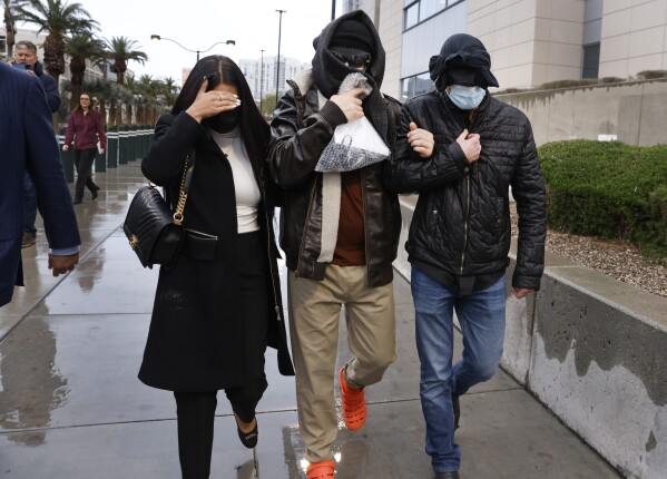 Former FBI informant Alexander Smirnov, center, leaves the courthouse on Tuesday, Feb. 20, 2024, in Las Vegas. Prosecutors say that Smirnov, who is charged with making up a multimillion-dollar bribery scheme involving President Joe Biden, his son Hunter and a Ukrainian energy company, had contacts with Russian intelligence-affiliated officials. (Bizuayehu Tesfaye/Las Vegas Review-Journal via AP)