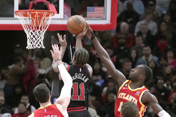 Atlanta Hawks' AJ Griffin, right, blocks Chicago Bulls' DeMar DeRozan's during the first half of an NBA basketball game Monday, Jan. 23, 2023, in Chicago. (AP Photo/Charles Rex Arbogast)