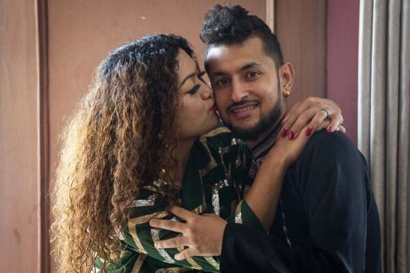 Same-sex couple Surendra Pandey, right, and Maya Gurung, who got married six years ago, pose for a photograph during an interview with the Associated Press in Kathmandu, Nepal, Thursday, June 29, 2023. LGBTQ+ rights activists and couples in Nepal on Thursday were celebrating an interim order issued by the country's Supreme Court enabling the registration of same-sex marriages for the first time. “I am overwhelmed with joy because of this decision and it is a day of commemoration for our community,” Gurung said. (AP Photo/Niranjan Shrestha)
