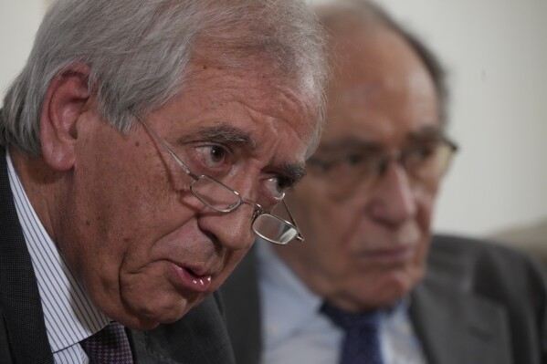FILE - Former Vatican's first auditor general, Libero Milone, left, speaks flanked by his lawyer Romano Vaccarella during a press conference at the Foreign Press Club in Rome, Thursday, Nov. 17, 2022. Two Vatican trials are coming to a head and posing uncomfortable questions for the Holy See, given they both underscore Pope Francis’ absolute power and the legal, financial and reputational problems that can arise when he wields it. (AP Photo/Domenico Stinellis, File)
