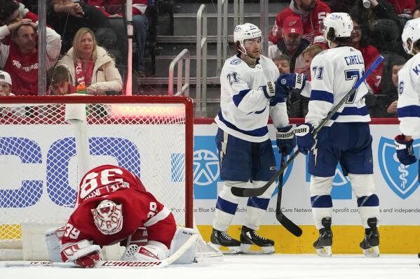 Tampa Bay Lightning center Brayden Point (21) celebrates his goal against Detroit Red Wings goaltender Alex Nedeljkovic (39) with Anthony Cirelli (71) during overtime against the Detroit Red Wings in an NHL hockey game Saturday, March 26, 2022, in Detroit. The Lightning won 2-1. (AP Photo/Paul Sancya)