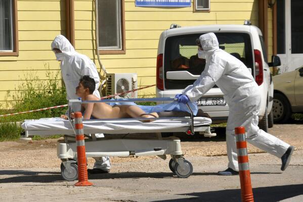 Turkish experts evacuate a victim of a suspected chemical weapons attacks in the Syrian city of Idlib, at a local hospital in Reyhanli, Turkey, Tuesday, April 4, 2017. A suspected chemical attack in a town in Syria's rebel-held northern Idlib province killed dozens of people on Tuesday, opposition activists said, describing the attack as among the worst in the country's six-year civil war. (DHA-Depo Photos via AP)