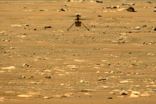 FILE - In this image made available by NASA, the Mars Ingenuity helicopter hovers above the surface of the planet during its second flight on April 22, 2021. On Thursday, Jan. 25, 2024, NASA announced that the 4-pound chopper can no longer fly because of rotor blade damage, and its mission is officially over. (NASA/JPL-Caltech/ASU/MSSS via AP, File)