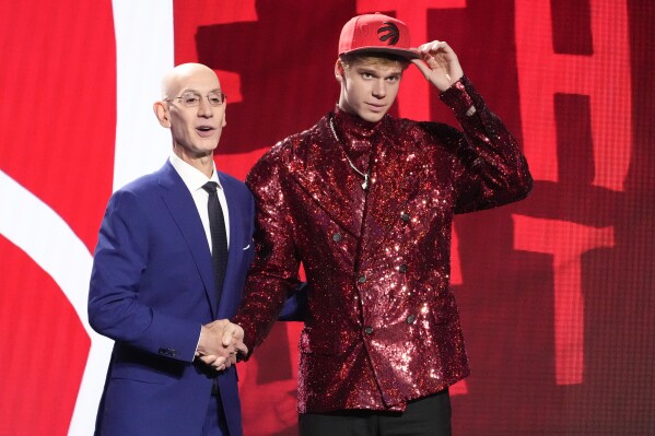 Gradey Dick poses for a photo with NBA Commissioner Adam Silver after being selected 13th overall by the Toronto Raptors during the NBA basketball draft, Thursday, June 22, 2023, in New York. (AP Photo/John Minchillo)