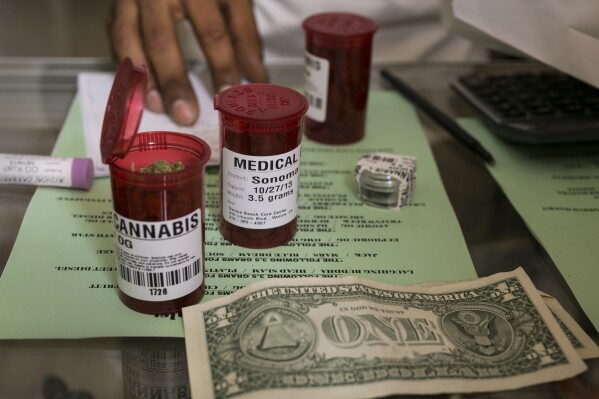 FILE - Medical marijuana prescription vials are filled at a medical marijuana dispensary in Venice, Calif., May 14, 2013. Georgia soon will become the first state in the nation to offer medical marijuana products at independent pharmacies, state officials said. The Georgia Board of Pharmacy began accepting applications early Oct. 2023, and nearly 120 pharmacies have agreed to provide medication from Botanical Sciences, one of the state’s two licensed production companies, The Atlanta Journal-Constitution reported. (AP Photo/Damian Dovarganes, File)