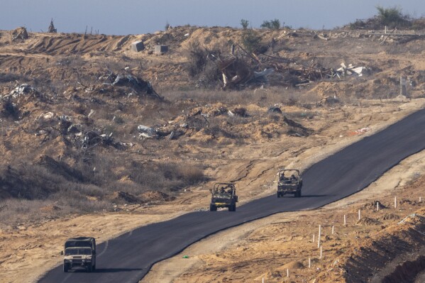 Israeli military vehicles move inside the Gaza Strip, as seen from southern Israel, Tuesday, Jan. 7, 2025. (AP Photo/Ariel Schalit, File)
