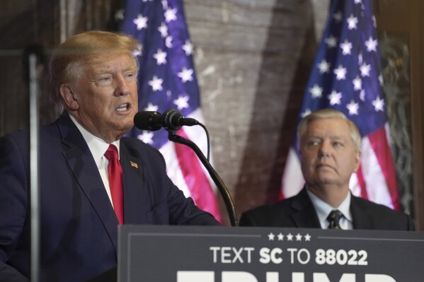 FILE - Former President Donald Trump, left, speaks at a campaign event as Sen. Lindsey Graham, R-S.C., looks on Jan. 28, 2023, in Columbia, S.C. The long and occasionally quixotic relationship between Trump and Graham has turned negative once more after the South Carolina senator criticized Trump's refusal to support a federal abortion ban. (AP Photo/Meg Kinnard, File)