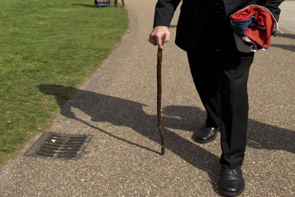 
              FILE - In this Thursday, April 25, 2013 file photo, Norwegian war hero and resistance fighter Joachim Roenneberg holds a Union flag as he walks in a park near the Palace of Westminster, after receiving the Union Jack Medal for his efforts and cooperation with the British during the second World War. Norway's leader says World War II saboteur Roenneberg has died at 99, it was reported on Monday, Oct. 22, 2018. In 1943, Roenneberg headed the four-man team that blew up a plant producing heavy water, which Nazi Germany could have used to produce nuclear weapons. P (AP Photo/Alastair Grant, File)
            
