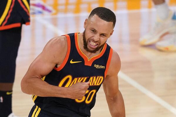 Golden State Warriors guard Stephen Curry celebrates after hitting a three-point shot at the end of the first half of an NBA basketball Western Conference Play-In game against the Los Angeles Lakers Wednesday, May 19, 2021, in Los Angeles. (AP Photo/Mark J. Terrill)