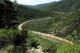 FILE - the Sonora River, contaminated by the spill of about 10 million gallons of copper sulfate and heavy metals from the Buenavista copper mine, makes its way through the hills near the town of Mazocahui in the northern state of Sonora, Mexico, Aug. 12, 2014. Residents in Mexico’s northern state of Sonora protested Tuesday, Dec. 5, 2023, against what they said is the government’s continued failure to clean up an almost decade-old mine spill. (APPhoto/El Imparcial, Julian Ortega, File)