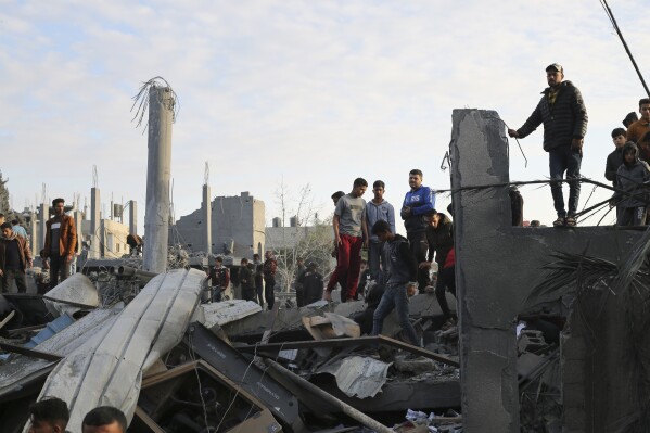 Palestinians look at a mosque destrooyed in an Israeli strike in Rafah, Gaza Strip. Wednesday, Jan. 24, 2024. (AP Photo/Hatem Ali)