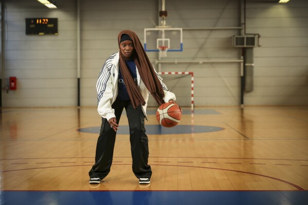 Former player Salimata Sylla poses for a photo before a women's basketball tournament where players can wear a headscarf, in Aubervilliers near Paris, Sunday, April 27, 2025. (AP Photo/Thomas Padilla)