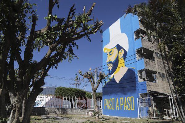 A mural promoting President Nayib Bukele, who is running for re-election, is displayed on the facade of a condominium in the Mejicanos suburb of San Salvador, El Salvador, Wednesday, Jan. 24, 2024.  (AP Photo/Salvador Melendez)