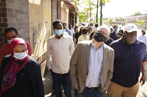 Minnesota Gov. Tim Walz walks with business owners that were affected by events following the George Floyd protests Friday, June 5, 2020 at Hawthorne Crossings in north Minneapolis. Floyd died after being restrained by Minneapolis police officers on May 25. (Anthony Souffle/Star Tribune via AP)