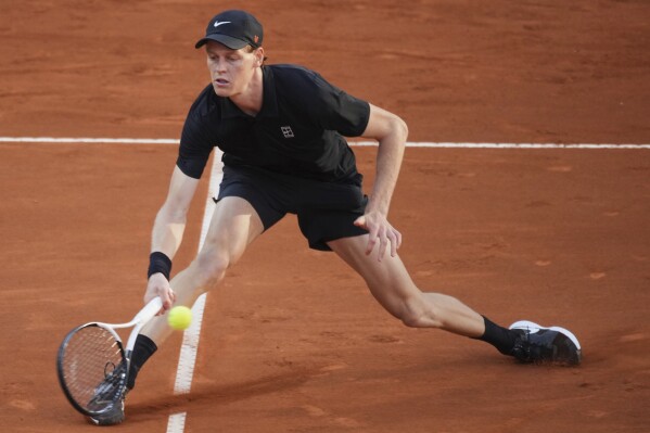 Jannik Sinner of Italy, returns to Carlos Alcaraz of Spain during their final tennis match in the Italian Open at the Foro Italico in Rome, Sunday, May 18, 2025. (AP Photo/Andrew Medichini)