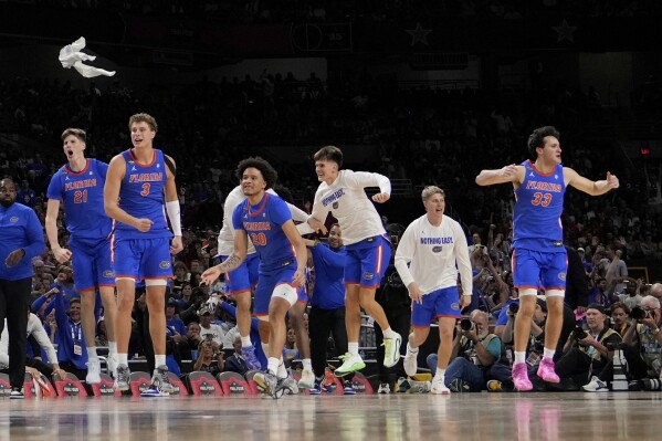Florida celebrates their win against Auburn in the national semifinals at the Final Four of the NCAA college basketball tournament, Saturday, April 5, 2025, in San Antonio. (AP Photo/Brynn Anderson)