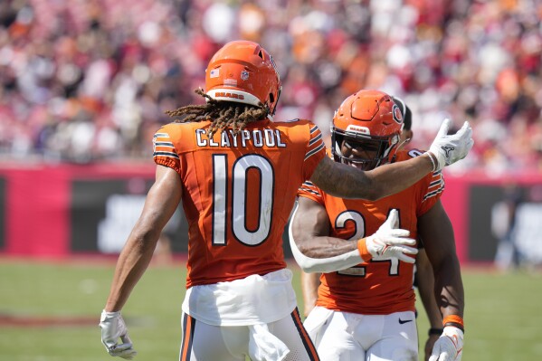 Chicago Bears wide receiver Chase Claypool (10) celebrates scoring a touchdown with teammate running back Khalil Herbert (24) during the second half of an NFL football game, Sunday, Sept. 17, 2023, in Tampa, Fla. (AP Photo/Chris O'Meara)