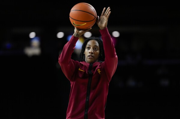 Southern California guard Aaliyah Gayles shoots before the team's NCAA college basketball game against Washington in Los Angeles, Sunday, Jan. 28, 2024. Aaliyah Gayles is helping revive Southern California's women's basketball program even though she's played sparingly this season.(AP Photo/Ashley Landis)