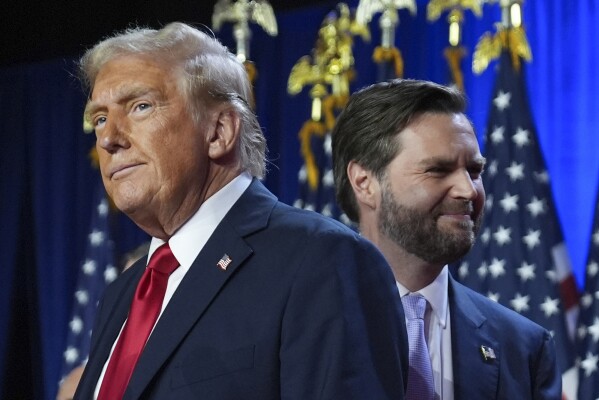 Republican presidential nominee former President Donald Trump, left, with Republican vice presidential nominee Sen. JD Vance, R-Ohio, right, are pictured at an election night watch party, Nov. 6, 2024, in West Palm Beach, Fla. (AP Photo/Evan Vucci, File)