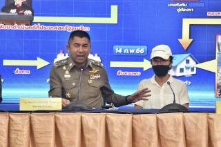 Deputy National Police Chief Surachet Hakpal, left, talks to reporters with Tubtim "Sue" Howson, 57, during press conference at police headquarter in Bangkok, Thailand, Wednesday, Feb. 15, 2023. Howson allegedly struck Michigan State University student Benjamin Kable, 22, shortly before dawn on Jan. 1. She flew to Thailand on a one-way ticket on Jan. 3, according to U.S. authorities. (Royal Thai Police via AP)
