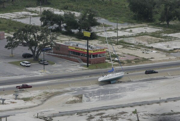 FILE - A sailboat washed out of the water during Hurricane Gustav. rests next to a road in Biloxi, Miss., Sept. 3, 2008. (AP Photo/James Edward Bates/Sun Herald, File)