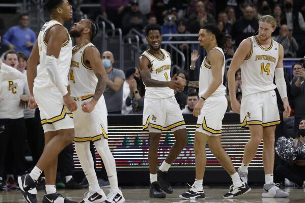 Providence players Ed Croswell, left, Jared Bynum (4), Al Durham (1), Alyn Breed, second right, and Noah Horchler (14) celebrate as they extend their lead late during the second half of an NCAA college basketball game against Butler, Sunday, Jan. 23, 2022, in Providence, R.I. (AP Photo/Mary Schwalm)