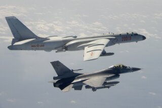 In this photo taken Feb. 10, 2020, and released by the Republic of China (ROC) Ministry of National Defense, a Taiwanese Air Force F-16 in foreground flies on the flank of a Chinese People's Liberation Army Air Force (PLAAF) H-6 bomber as it passes near Taiwan. (Republic of China (ROC) Ministry of National Defense via AP)