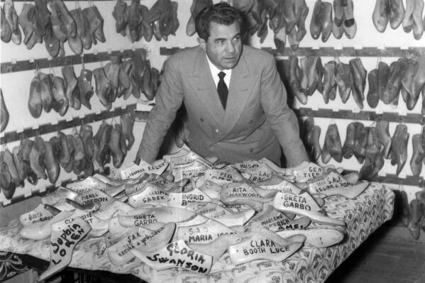 This image released by Sony Pictures Classics shows Italian designer Salvatore Ferragamo with some of his shoe shapes. Ferragamo is the subject of the documentary "Salvatore: Shoemaker of Dreams." (©Archivio Giuseppe Palmas/Sony Pictures Classics via AP)