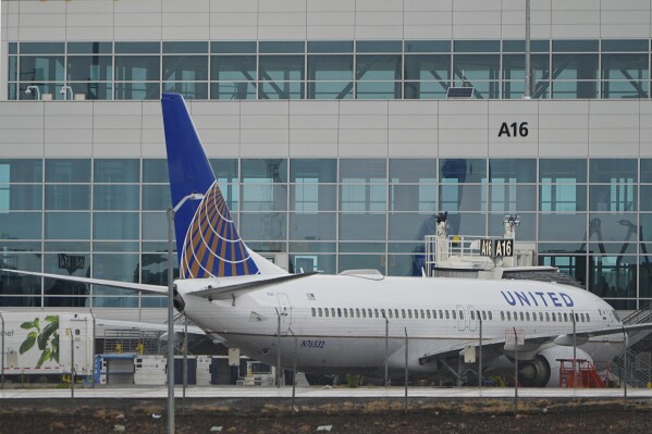A United Airlines jetliner prepares to push off from a gate at Denver International Airport Wednesday, May 7, 2025, in Denver. (AP Photo/David Zalubowski)