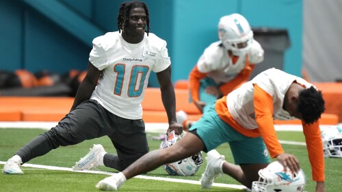 Miami Dolphins wide receiver Tyreek Hill (10) stretches during practice at the NFL football team's training facility, Tuesday, June 6, 2023, in Miami Gardens, Fla. (AP Photo/Lynne Sladky)