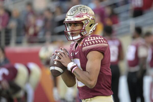 FILE - Florida State quarterback Jordan Travis (13) warms up before the Cheez-It Bowl NCAA college football game against Oklahoma, Thursday, Dec. 29, 2022, in Orlando, Fla. Behind fifth-year quarterback Jordan Travis, a candidate for ACC player of the year, and a deep and talented offensive line, the Seminoles and fourth-year coach Norvell look ready to once more take over the league. (AP Photo/Phelan M. Ebenhack, File)