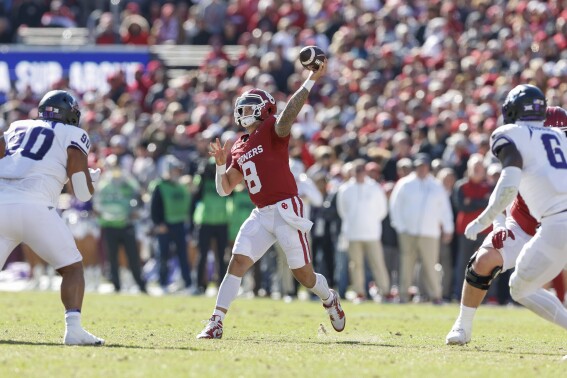 Oklahoma quarterback Dillon Gabriel (8) passes against TCU during the first half of an NCAA college football game Friday, Nov. 24, 2023, in Norman, Okla. (AP Photo/Alonzo Adams)