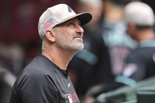 Arizona Diamondbacks manager Torey Lovullo pauses in the dugout prior to a baseball game against the Colorado Rockies Saturday, May 17, 2025, in Phoenix. (AP Photo/Ross D. Franklin)
