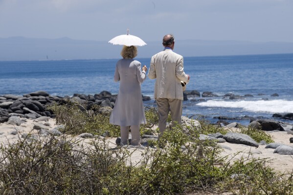 Britain's Prince Charles and Camilla, the Duchess of Cornwall look out to sea, during a visit to North Seymour Island in the Galapagos Islands, Ecuador, Tuesday March 17, 2009. (Arthur Edwards, Pool photo via AP, File)