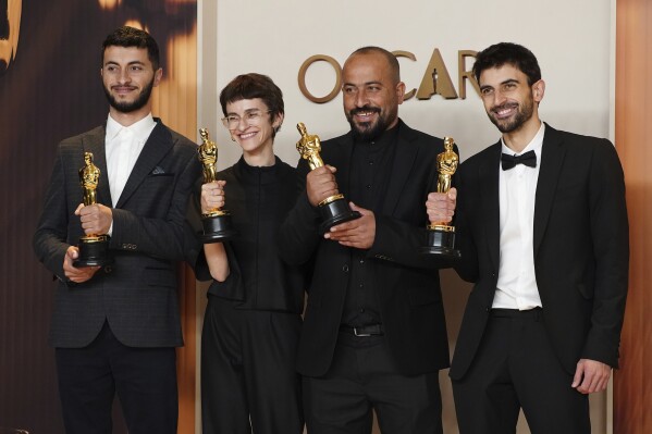 Basel Adra, from left, Rachel Szor, Hamdan Ballal, and Yuval Abraham, winners of the award for best documentary feature film for No Other Land, pose in the press room at the Oscars on Sunday, March 2, 2025, at the Dolby Theatre in Los Angeles. (Photo by Jordan Strauss/Invision/AP)