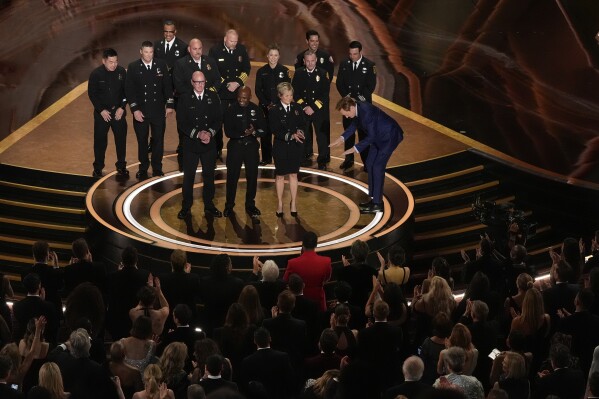 Members of the Los Angeles Fire Department and Host Conan O'Brien on stage during the Oscars on Sunday, March 2, 2025, at the Dolby Theatre in Los Angeles. (AP Photo/Chris Pizzello)
