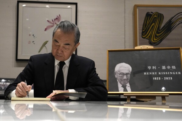Chinese Foreign Minister Wang Yi signs a condolence book for the late Henry Kissinger at the U.S. embassy in Beijing, Tuesday, Dec. 5, 2023. Official China called Kissinger "an old friend." A commentator likened him to a giant panda, a goodwill ambassador between two countries that have been more often at odds over the decades than not. Kissinger, who died Wednesday, Nov. 29, 2023, developed a special relationship with China in the second half of his 100-year-long life. (AP Photo/Ng Han Guan, Pool)