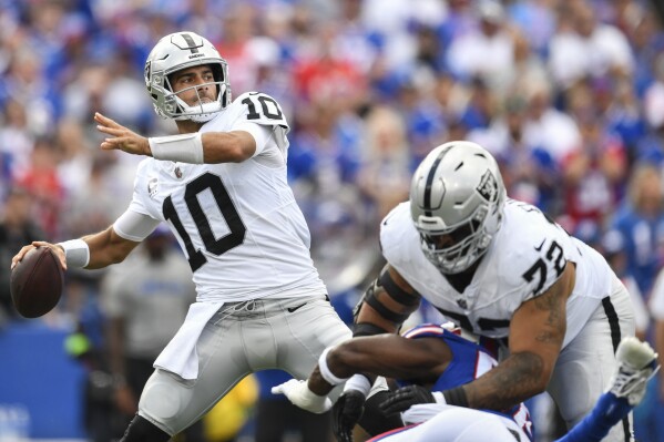 Las Vegas Raiders quarterback Jimmy Garoppolo (10) throws a pass as guard Jermaine Eluemunor (72) blocks for him during the first half of an NFL football game against the Buffalo Bills, Sunday, Sept. 17, 2023, in Orchard Park, N.Y. (AP Photo/Adrian Kraus)