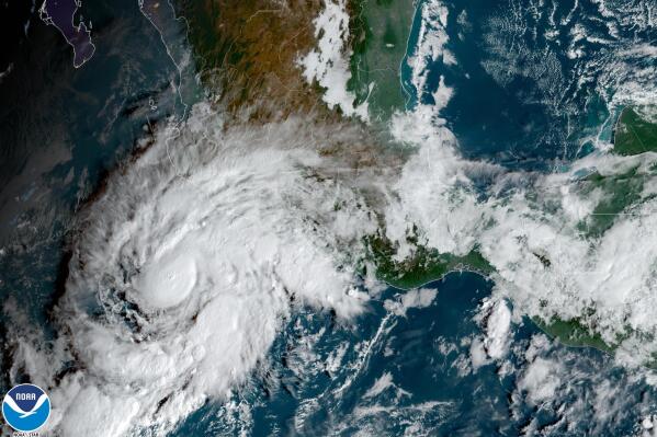 This satellite image taken at 10am ET and provided by NOAA shows Tropical Storm Roslyn approaching the Pacific coast of Mexico, Friday, Oct. 21, 2022. Forecasters expect it to be a hurricane when it makes a likely weekend landfall between the resorts of Puerto Vallarta and Mazatlan. (NOAA via AP)