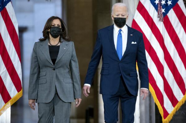 President Joe Biden and Vice President Kamala Harris arrive to speak from Statuary Hall at the U.S. Capitol to mark the one year anniversary of the Jan. 6 riot at the U.S. Capitol by supporters loyal to then-President Donald Trump, Thursday, Jan. 6, 2022, in Washington. (Greg Nash/Pool via AP)