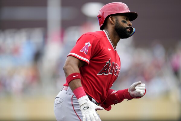 Los Angeles Angels' Jo Adell runs the bases after hitting a solo home run during the fourth inning of a baseball game against the Minnesota Twins, Saturday, Sept. 23, 2023, in Minneapolis. (AP Photo/Abbie Parr)