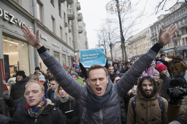 FILE - Russian opposition leader Alexei Navalny, center, attends a rally in Moscow on Sunday, Jan. 28, 2018. During his 24-year rule, Russian President Vladimir Putin has gone from tolerating dissent to suppressing any challenger. Most Russian opposition politicians are in prison or exile. (AP Photo/Evgeny Feldman, File)