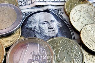 FILE - In this Feb. 27, 2008 file photo, euro coins and dollar bills are seen in Frankfurt, central Germany. The U.S. dollar has been surging in 2022, so much that it's nearly equal in value to the euro for the first time in 20 years. That trend, though, threatens to hurt American companies because their goods become more expensive for foreign buyers. If U.S. exports were to weaken as a result, so, too, would the already-slowing U.S. economy. (AP Photo/Michael Probst, File)