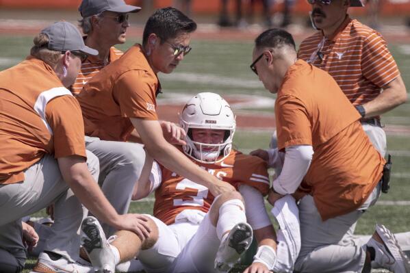 Texas quarterback Quinn Ewers (3) is helped up off the ground after a hit and personal foul by Alabama linebacker Dallas Turner during the first half of an NCAA college football game, Saturday, Sept. 10, 2022, in Austin, Texas. Texas' Ewers was injured on the play leaving the game. Ewers did not return to the game. (AP Photo/Rodolfo Gonzalez)